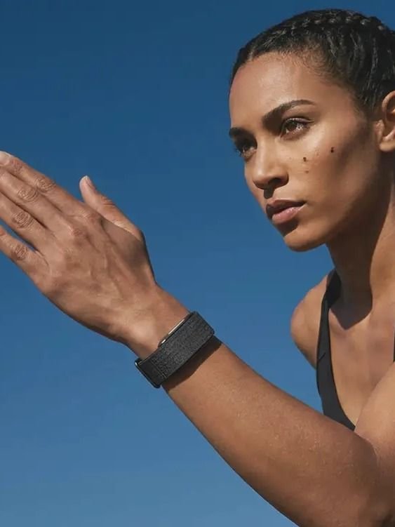 Sportliche Frau im Freien trägt das Hume Band und baut Metabolic Momentum auf